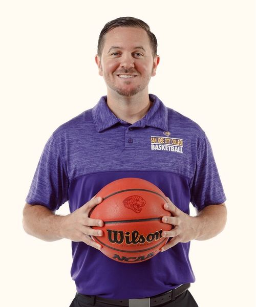 Coach Devin Aye smiling in a portrait