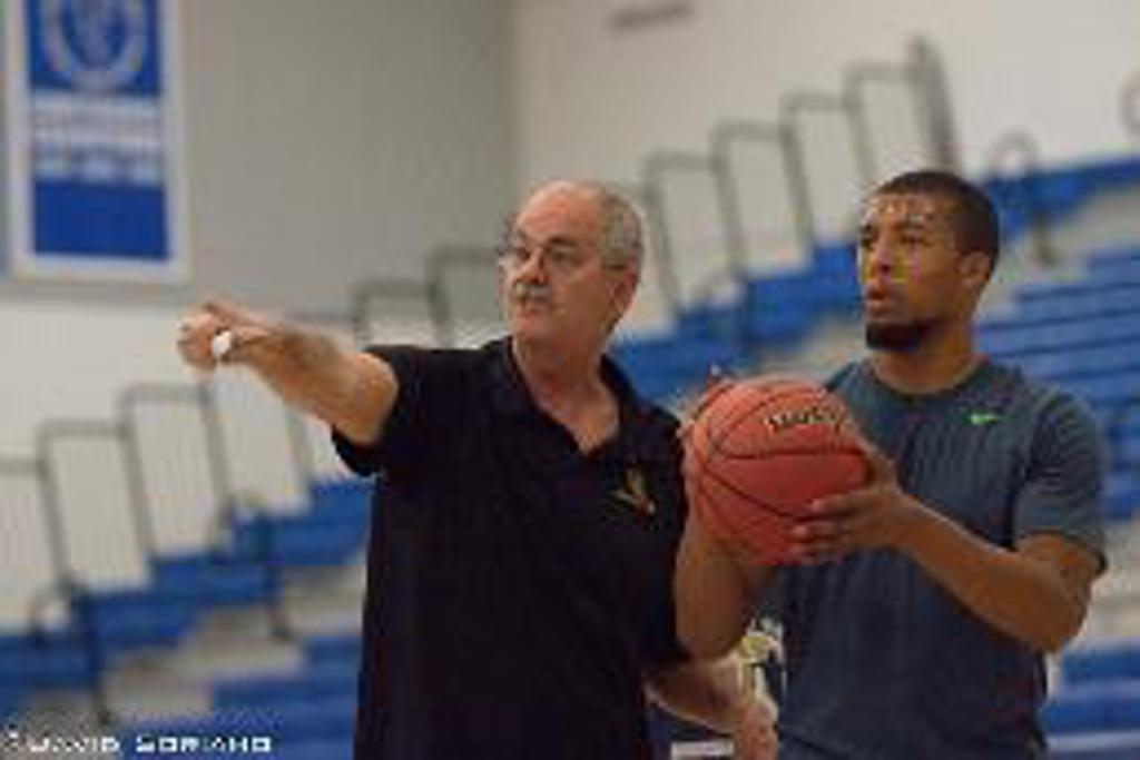 Coach Denny Aye with Jalen on a basketball court